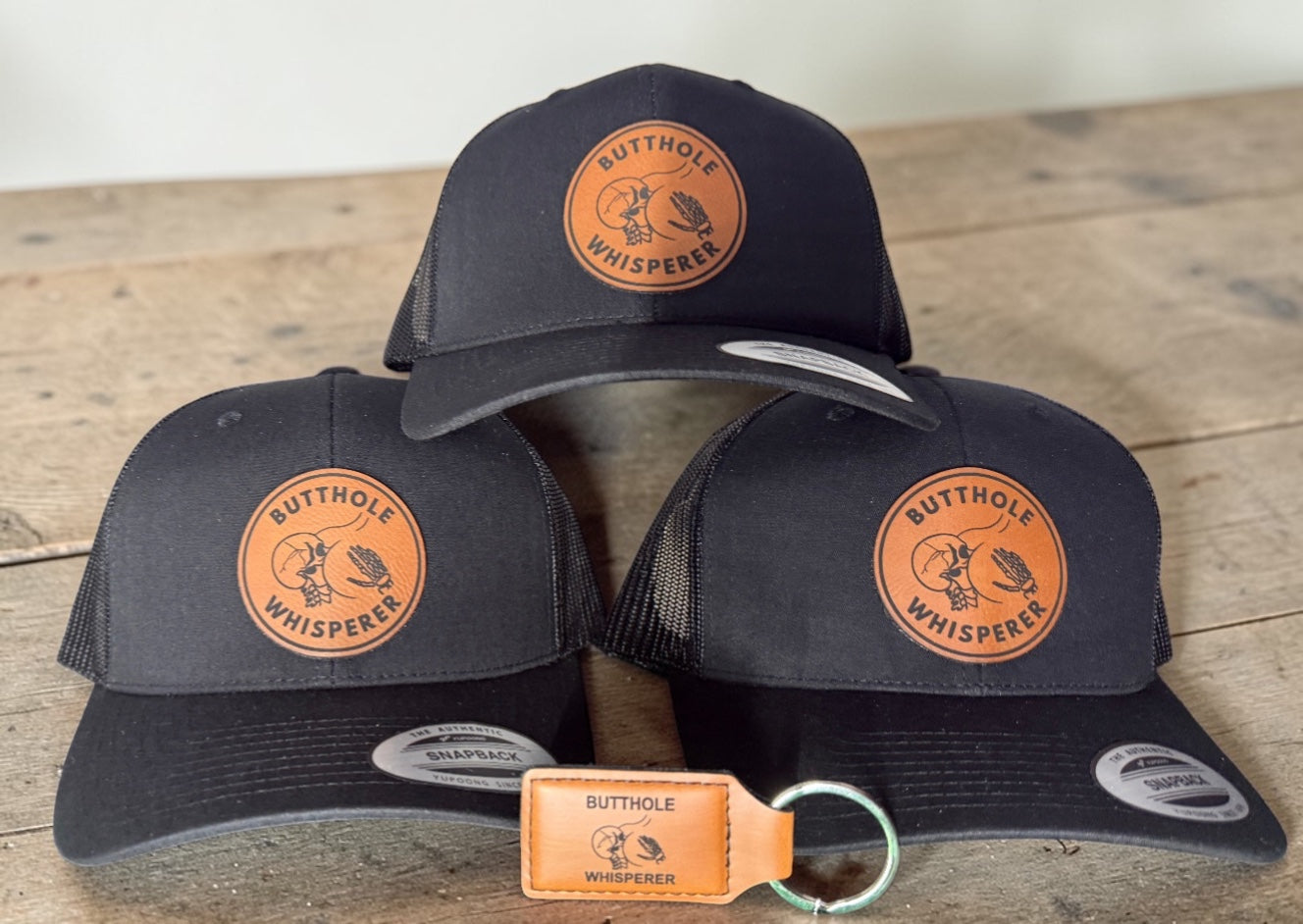 Butthole Whisperer Patched Hat | Black on Black Yupoong Classic Snapback | Funny Hat with Free Matching Keychain!